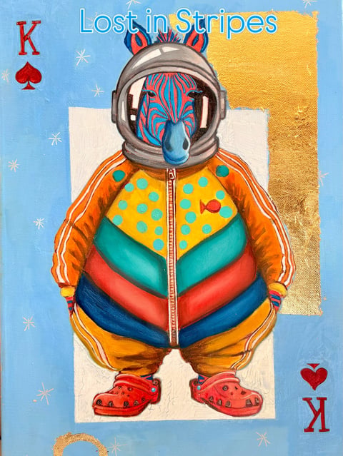 Colorful striped alien astronaut figure in space helmet with blue face, wearing orange and yellow patterned jacket against blue background with stars and gold accents