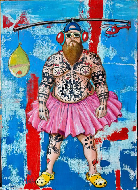 Bearded man with tattoos wearing pink tutu and yellow shoes, holding helicopter, against blue and red distressed background